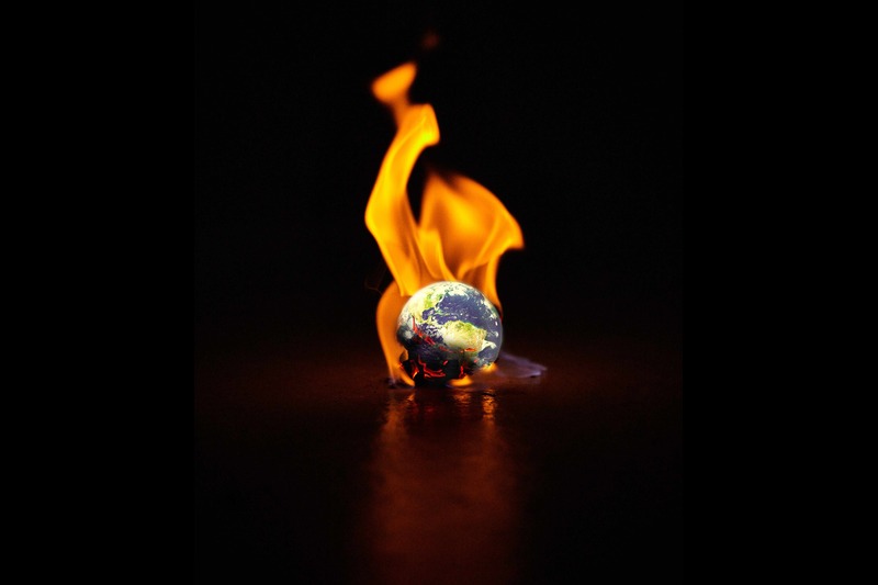 Shot of the earth engulfed in flames against a black background. Image by YuriArcursPeopleimages, Envato