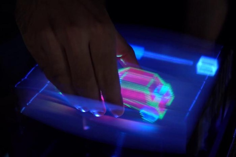 A 3D car is grabbed and rotated by a user.